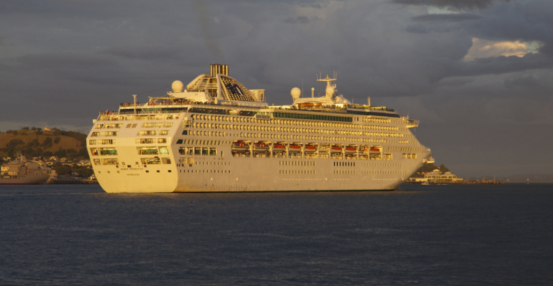 A cruise ship leaves Auckland Harbour at sunset