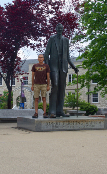 Standing beside a life-sized statue of Robert Wadlow - the world's tallest person - in Alton, IL