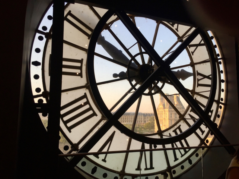 Looking through the clock from inside the Orsay Museum at sunset