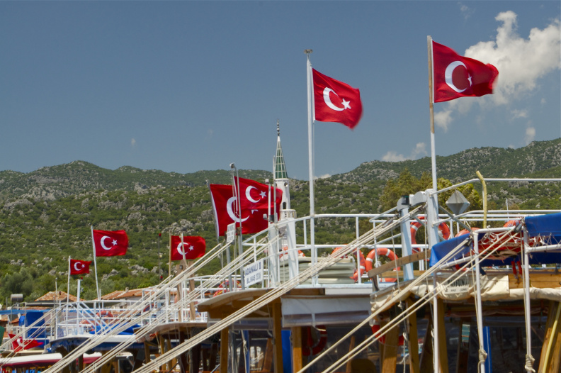 Turkish flags flying above yachts moored at Üçaǧiz