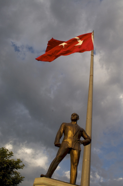 Statue of Ataturk, underneath the Turkish flag