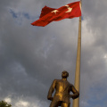Statue of Ataturk, underneath the Turkish flag